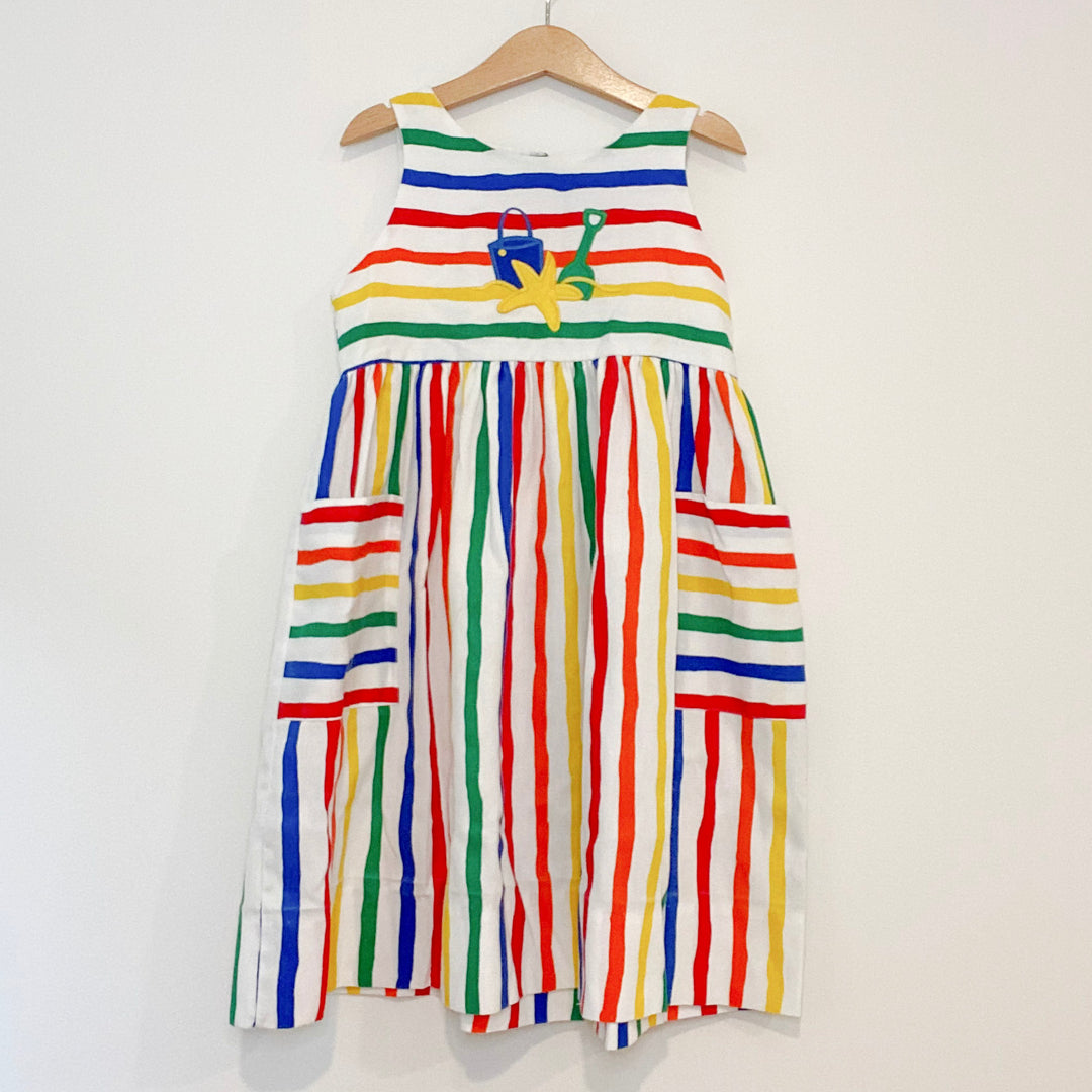 rainbow striped dress with beach appliqué on front from Kelly’s Kids.